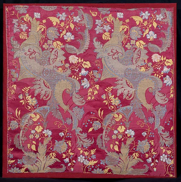 Bizarre Silk, French or Italian, Claret coloured damask, the pattern brocaded in silver & silver gilt thread with floral motifs in blue yellow & white silks, 1700 - 1705, 56.5 x 56 cms